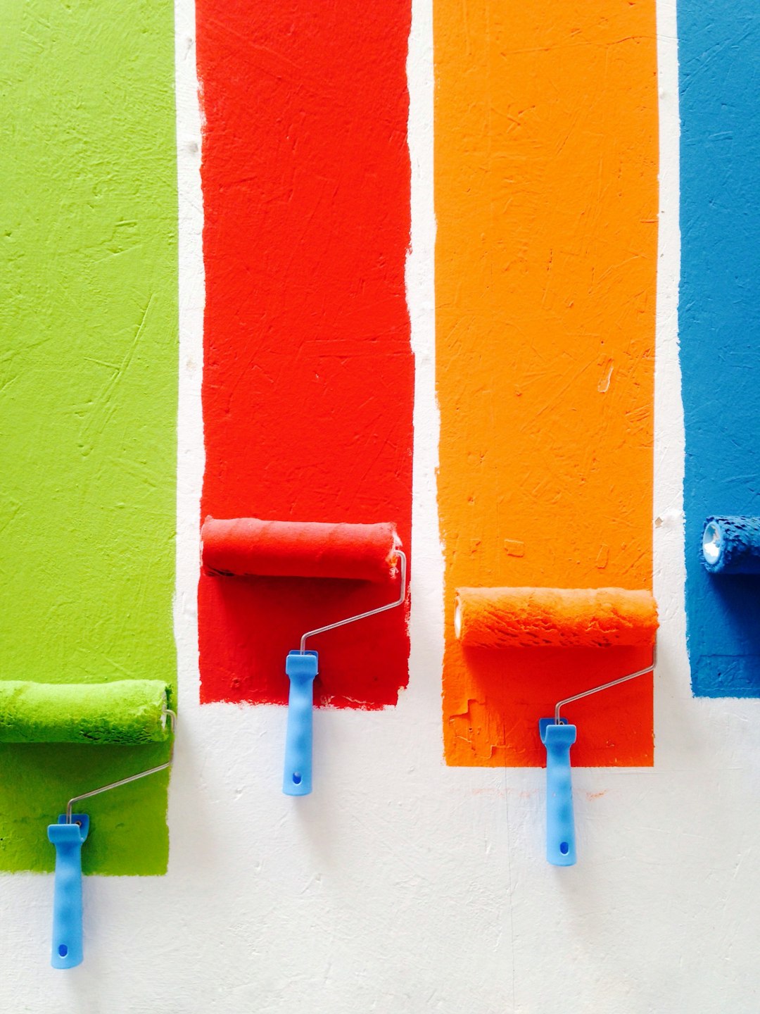project-02-c four-orange-green-blue-and-red-paint-rollers-46jud4zy1xa